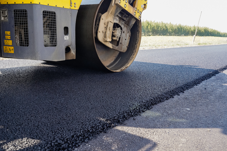 road equipment lays asphalt, road works, paver, road repairs