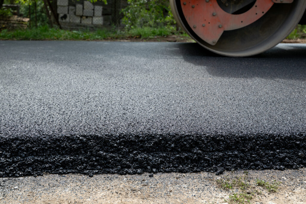 Road roller compacting new asphalt layer