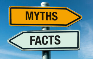 Signpost with arrows labeled “Myths” and “Facts” symbolizing common misconceptions versus truths about asphalt rejuvenation and RAP use in paving.