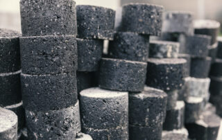 Samples of asphalt depicting reclaimed asphalt and recycled asphalt with asphalt rejuvenators for testing balanced mix design and performance.