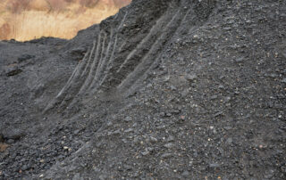 Recycled asphalt pavement (RAP) stockpile from road milling at asphalt plant, showcasing sustainable asphalt paving, asphalt rejuvenation, and material reuse in the asphalt industry