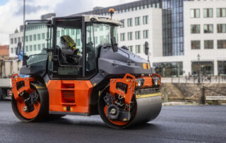An asphalt drum compactor smooths a new roadway surface more easily when the right asphalt softener is used during mix production.