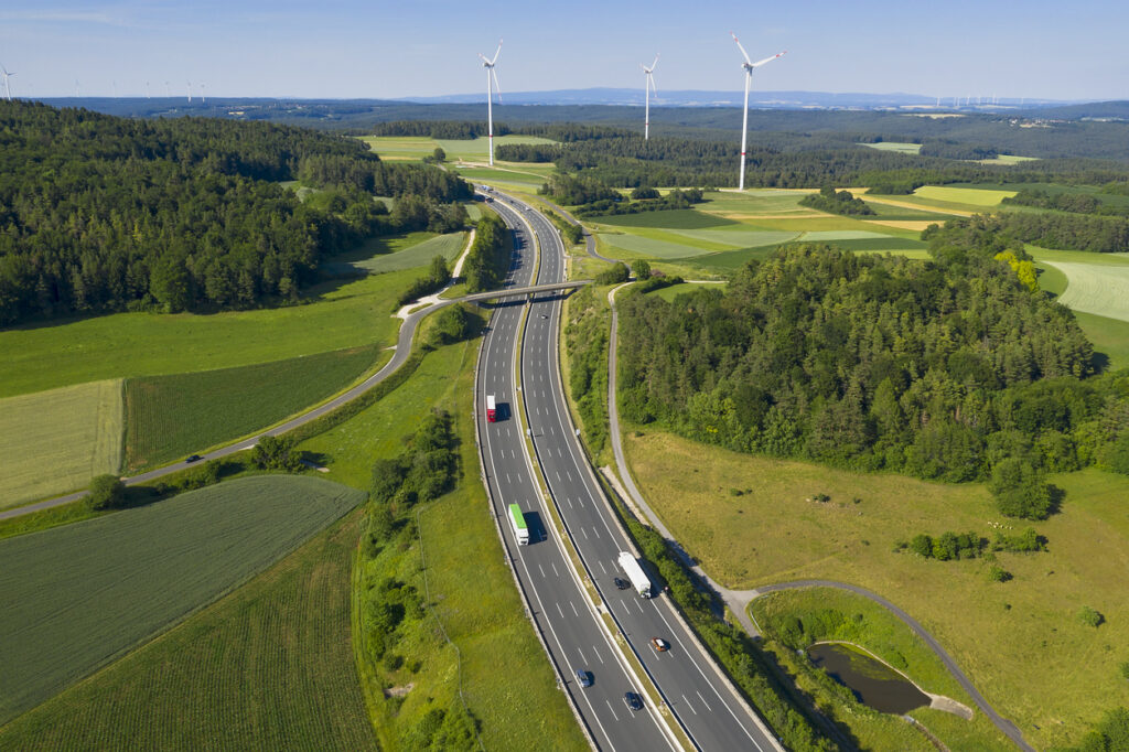 Multilane highway experiencing high traffic where it is beneficial to extend asphalt lifespan by using sustainable bitumen additives to improve performance and durability. 