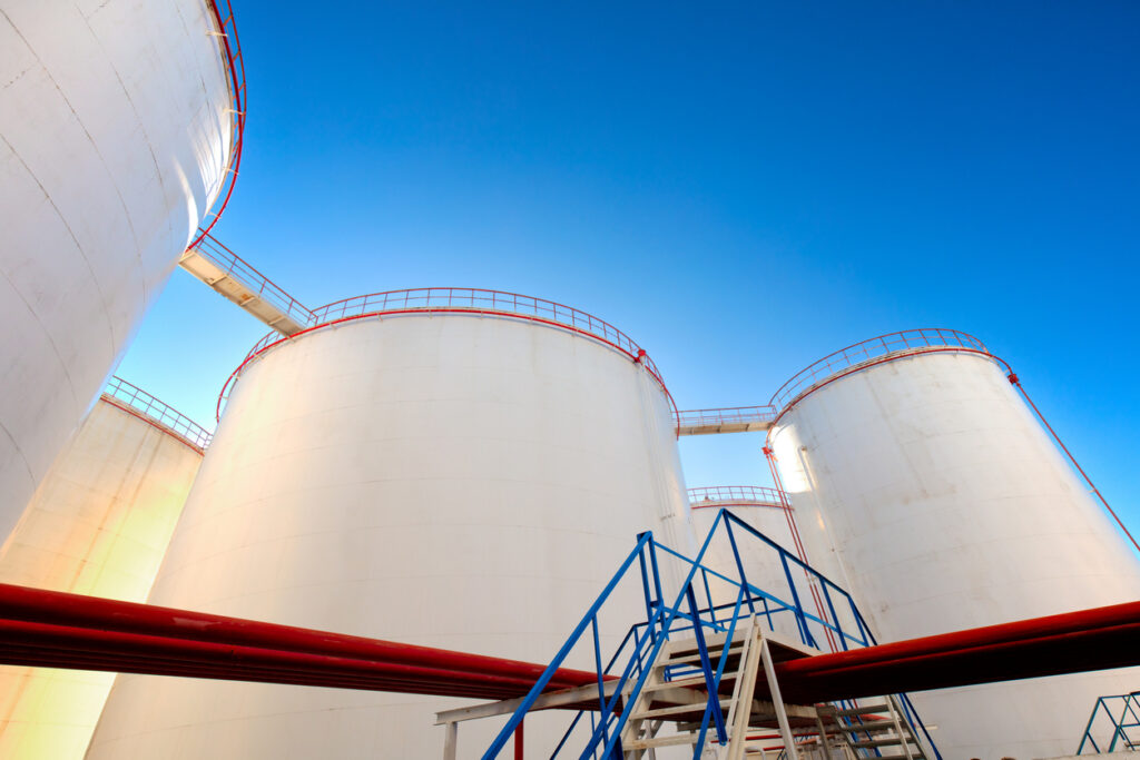 ndustrial oil storage tanks and pipelines representing bulk bitumen and petroleum product handling infrastructure.