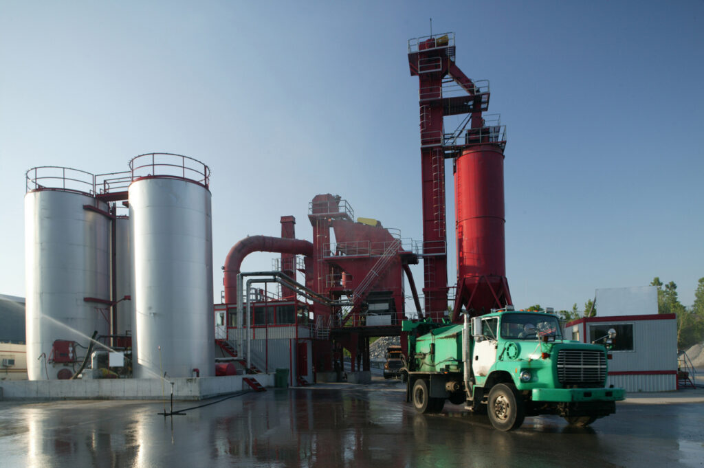 asphalt factory front view on sunny day Asphalt production plant exterior showing industrial facility for bitumen and PMB manufacturing.