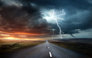 Extreme weather conditions, including heavy rain and lightning, contribute to asphalt aging, moisture damage, and reduced pavement durability over time.