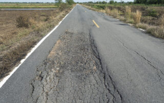 Asphalt roadways surface deformed over time due to the impact of traffic and environmental conditions.
