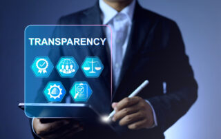 Business professional holding a transparent glass panel representing transparency in the asphalt additive industry and data-driven asphalt innovation.