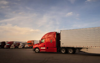 Semi-truck at a rest area, representing the professional drivers who keep materials moving through the supply chain.